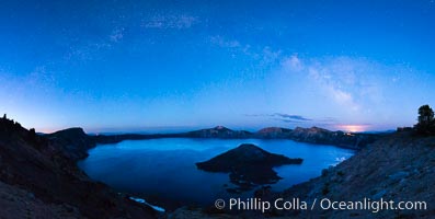 Milky Way and stars over Crater Lake at night. Panorama of Crater Lake and Wizard Island at night, Crater Lake National Park.