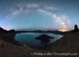 Milky Way and stars over Crater Lake at night. Panorama of Crater Lake and Wizard Island at night, Crater Lake National Park