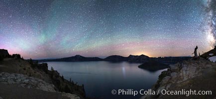 Air glow faint aurora borealis and stars over Crater Lake at night. Panorama of Crater Lake and Wizard Island at night, Crater Lake National Park