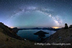 Milky Way and stars over Crater Lake at night. Panorama of Crater Lake and Wizard Island at night, Crater Lake National Park