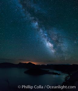 Milky Way and stars over Crater Lake at night. Panorama of Crater Lake and Wizard Island at night, Crater Lake National Park