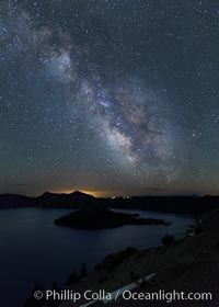 Milky Way and stars over Crater Lake at night. Panorama of Crater Lake and Wizard Island at night, Crater Lake National Park