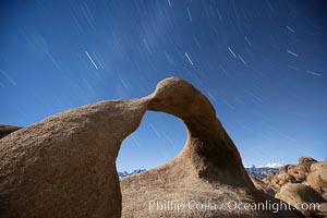 Mobius Arch in the Alabama Hills, seen here at night with swirling star trails formed in the sky above due to a long time exposure, Alabama Hills Recreational Area