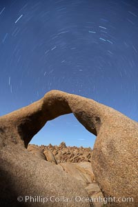 Mobius Arch in the Alabama Hills, seen here at night with swirling star trails formed in the sky above due to a long time exposure, Alabama Hills Recreational Area