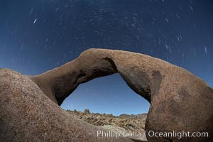 Mobius Arch in the Alabama Hills, seen here at night with swirling star trails formed in the sky above due to a long time exposure, Alabama Hills Recreational Area