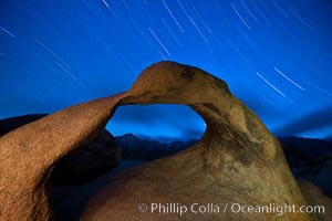 Mobius Arch in the Alabama Hills, seen here at night with swirling star trails formed in the sky above due to a long time exposure, Alabama Hills Recreational Area