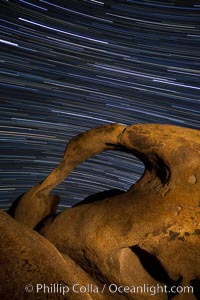 Mobius Arch in the Alabama Hills, seen here at night with swirling star trails formed in the sky above due to a long time exposure, Alabama Hills Recreational Area