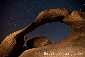 Mobius Arch in the Alabama Hills, seen here at night with swirling star trails formed in the sky above due to a long time exposure, Alabama Hills Recreational Area