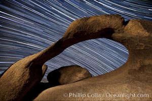 Mobius Arch in the Alabama Hills, seen here at night with swirling star trails formed in the sky above due to a long time exposure, Alabama Hills Recreational Area