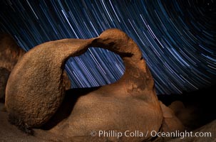 Mobius Arch in the Alabama Hills, seen here at night with swirling star trails formed in the sky above due to a long time exposure. Polaris, the North Star, is visible at upper right, Alabama Hills Recreational Area