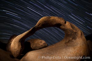 Mobius Arch in the Alabama Hills, seen here at night with swirling star trails formed in the sky above due to a long time exposure.