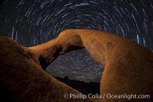 Mobius Arch in the Alabama Hills, seen here at night with swirling star trails formed in the sky above due to a long time exposure. Alabama Hills Recreational Area, California, USA, natural history stock photograph, photo id 27681