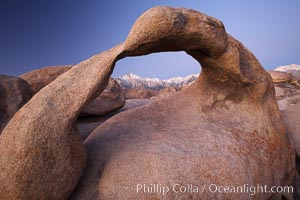 Mobius Arch at sunrise, with Mount Whitney (the tallest peak in the continental United States), Lone Pine Peak and snow-covered Sierra Nevada Range framed within the arch.  Mobius Arch is a 17-foot-wide natural rock arch in the scenic Alabama Hills Recreational Area near Lone Pine, California