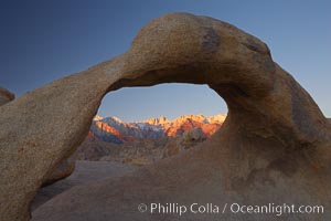 Mobius Arch, with snow covered Mt. Whitney and the Sierra Nevada Range framed within the natural stone arch.  Mt. Whitney is the highest peak in the continental United States, Alabama Hills Recreational Area