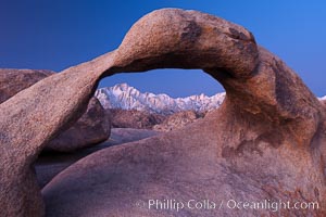 Mobius Arch at sunrise, framing snow dusted Lone Pine Peak and the Sierra Nevada Range in the background. Also known as Galen's Arch, Mobius Arch is found in the Alabama Hills Recreational Area near Lone Pine