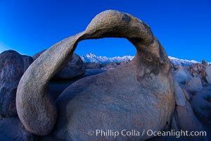 Mobius Arch at sunrise, framing snow dusted Lone Pine Peak and the Sierra Nevada Range in the background. Also known as Galen's Arch, Mobius Arch is found in the Alabama Hills Recreational Area near Lone Pine