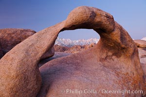 Mobius Arch at sunrise, framing snow dusted Lone Pine Peak and the Sierra Nevada Range in the background. Also known as Galen's Arch, Mobius Arch is found in the Alabama Hills Recreational Area near Lone Pine