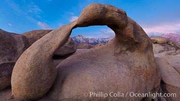 Mobius Arch at sunrise, framing snow dusted Lone Pine Peak and the Sierra Nevada Range in the background. Also known as Galen's Arch, Mobius Arch is found in the Alabama Hills Recreational Area near Lone Pine