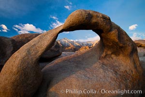 Mobius Arch at sunrise, framing snow dusted Lone Pine Peak and the Sierra Nevada Range in the background. Also known as Galen's Arch, Mobius Arch is found in the Alabama Hills Recreational Area near Lone Pine