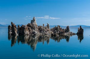 Tufa towers rise from Mono Lake.  Tufa towers are formed when underwater springs rich in calcium mix with lakewater rich in carbonates, forming calcium carbonate (limestone) structures below the surface of the lake.  The towers were eventually revealed when the water level in the lake was lowered starting in 1941.  South tufa grove, Navy Beach