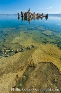 Tufa towers rise from Mono Lake.  Tufa towers are formed when underwater springs rich in calcium mix with lakewater rich in carbonates, forming calcium carbonate (limestone) structures below the surface of the lake.  The towers were eventually revealed when the water level in the lake was lowered starting in 1941.  South tufa grove, Navy Beach