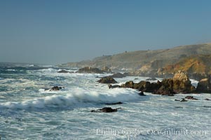 Waves blur as they break over the rocky shoreline of Big Sur