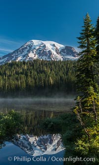 Mount Rainier is reflected in the calm waters of Reflection Lake, early morning
