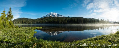 Mount Rainier is reflected in the calm waters of Reflection Lake, early morning