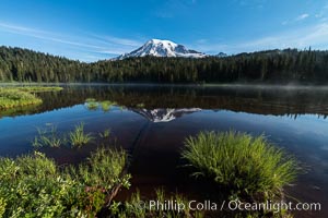 Mount Rainier is reflected in the calm waters of Reflection Lake, early morning, Mount Rainier National Park, Washington