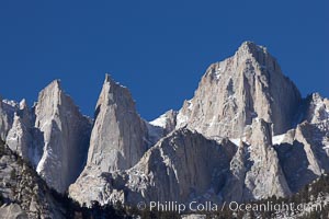 Mt. Whitney is the highest point in the contiguous United States with an elevation of 14,505 feet (4,421 m).  It lies along the crest of the Sierra Nevada mountain range.  Composed of the Sierra Nevada batholith granite formation, its eastern side (seen here) is quite steep.  It is climbed by hundreds of hikers each year