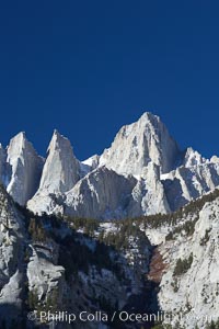 Mt. Whitney is the highest point in the contiguous United States with an elevation of 14,505 feet (4,421 m).  It lies along the crest of the Sierra Nevada mountain range.  Composed of the Sierra Nevada batholith granite formation, its eastern side (seen here) is quite steep.  It is climbed by hundreds of hikers each year