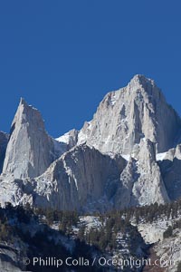 Mt. Whitney is the highest point in the contiguous United States with an elevation of 14,505 feet (4,421 m).  It lies along the crest of the Sierra Nevada mountain range.  Composed of the Sierra Nevada batholith granite formation, its eastern side (seen here) is quite steep.  It is climbed by hundreds of hikers each year