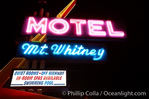 Mt. Whitney Hotel, near signs at night, Lone Pine, California