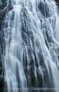 Narada Falls cascades down a cliff, with the flow blurred by a time exposure. Narada Falls is a 188 foot (57m) waterfall in Mount Rainier National Park