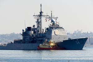 Navy ship with tug boat alongside, San Diego, California