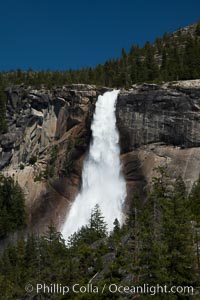 Nevada Falls viewed from the John Muir Trail, Merced River in peak spring flow from heavy snow melt in the high country above Yosemite Valley, Yosemite National Park, California