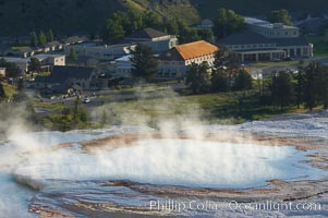 New Blue Spring steams in the cold morning air with Mammoth Hot Springs Inn in the distance. Yellowstone National Park, Wyoming, USA, natural history stock photograph, photo id 13610