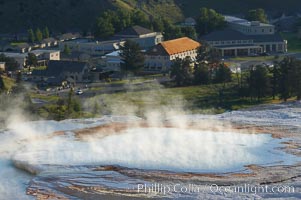 New Blue Spring steams in the cold morning air with Mammoth Hot Springs Inn in the distance, Yellowstone National Park, Wyoming