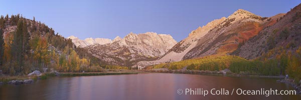 North Lake lit by alpenglow before sunrise, a three frame panorama, with groves of yellow and orange aspen trees on the side of Paiute Peak, Bishop Creek Canyon, Sierra Nevada Mountains