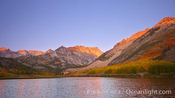 North Lake lit by alpenglow before sunrise, a three frame panorama, with groves of yellow and orange aspen trees on the side of Paiute Peak, Bishop Creek Canyon, Sierra Nevada Mountains