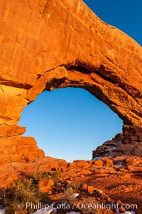 North Window glows red at sunset.  North Window is a natural sandstone arch 90 feet wide and 48 feet high, Arches National Park, Utah