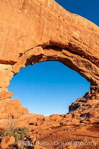 North Window glows red at sunset.  North Window is a natural sandstone arch 90 feet wide and 48 feet high, Arches National Park, Utah