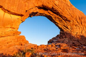 North Window glows red at sunset.  North Window is a natural sandstone arch 90 feet wide and 48 feet high, Arches National Park, Utah