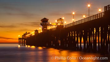 Oceanside Pier at sunset, clouds with a brilliant sky at dusk, the lights on the pier are lit