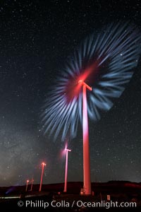 Ocotillo Wind Energy Turbines, at night with stars and the Milky Way in the sky above, the moving turbine blades illuminated by a small flashlight