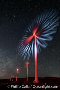 Ocotillo Wind Energy Turbines, at night with stars and the Milky Way in the sky above, the moving turbine blades illuminated by a small flashlight