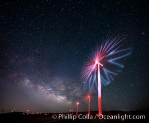 Ocotillo Wind Energy Turbines, at night with stars and the Milky Way in the sky above, the moving turbine blades illuminated by a small flashlight