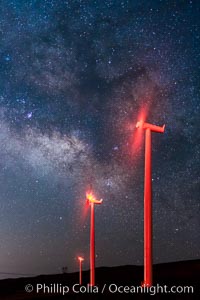 Ocotillo Wind Energy Turbines, at night with stars and the Milky Way in the sky above, the moving turbine blades illuminated by a small flashlight