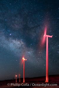 Ocotillo Wind Energy Turbines, at night with stars and the Milky Way in the sky above, the moving turbine blades illuminated by a small flashlight