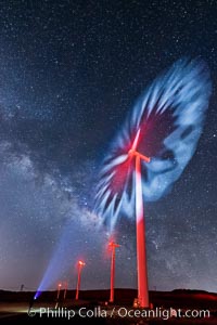 Ocotillo Wind Energy Turbines, at night with stars and the Milky Way in the sky above, the moving turbine blades illuminated by a small flashlight